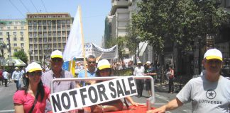 Greek postal workers march through Athens with a clear message in English: the postal service is ‘not for sale’!