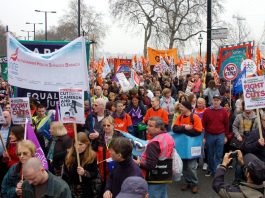 Union banners from Unite and the GMB on the 500,000-strong TUC demonstration against cuts on March 26