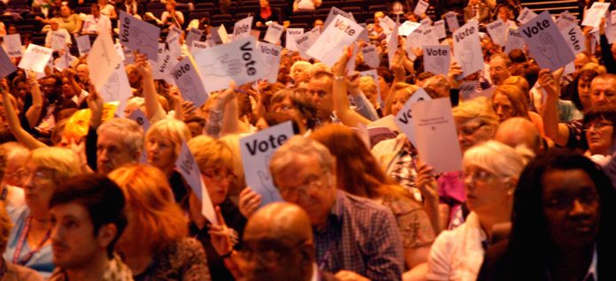 Unison conference delegates voting to oppose the coalition’s attacks on health, education and pensions