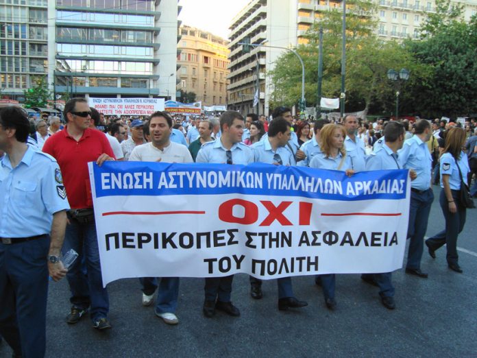 Greek police marching against the cuts in Vouli square, opposite the parliament building