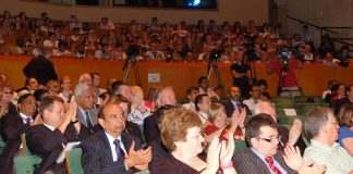 Delegates applaud at the BMA’s ARM on Monday as doctors condemned cuts to the NHS