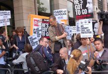 Demonstrators outside yesterday’s hearings where MPs questioned the Murdochs and sacked police chiefs, demanding that Cameron and Murdoch go