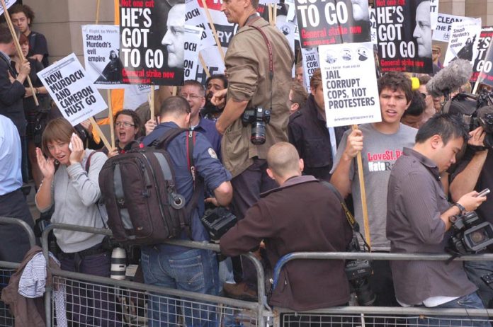 Demonstrators outside the parliamentary hearings where James and Rupert Murdoch were quizzed by MPs this week