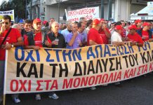 A section of demonstrating taxi drivers with their banner stating ‘No to the monopolies and cartels’