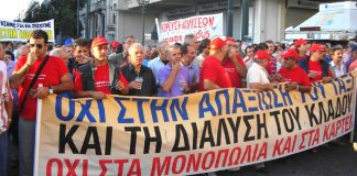 A section of demonstrating taxi drivers with their banner stating ‘No to the monopolies and cartels’