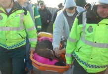 Nora Egan being stretchered away and taken to Basildon General Hospital after being injured in the police-led raid on her home early yesterday morning