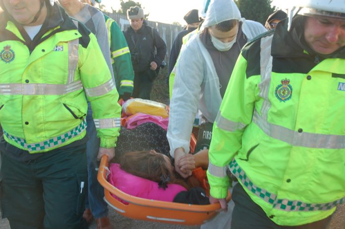 Nora Egan being stretchered away and taken to Basildon General Hospital after being injured in the police-led raid on her home early yesterday morning