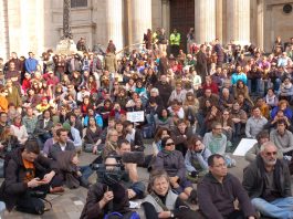 Hundreds of people listening to a speaker at the St Paul’s camp