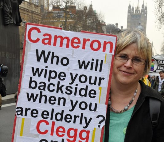 A demonstrator in London in March condemns the coalition’s savage cuts to services