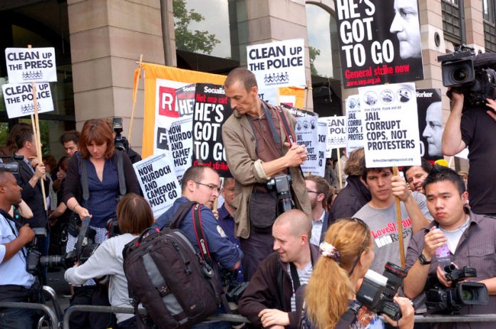 Protesters outside the Culture Committee in July as Rupert Murdoch appeared