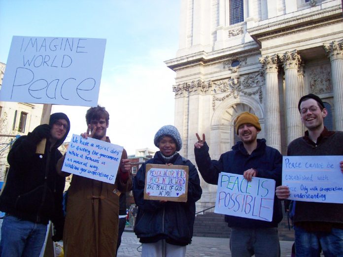 A group of Occupy London campaigners outside St Paul’s Cathedral before their peace walk to Westminster