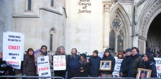 Demonstrators outside the High Court show their support for Julian Assange