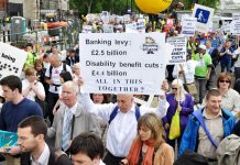 Disabled people and their supporters marching last May against benefit cuts