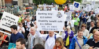 Disabled people and their supporters marching last May against benefit cuts