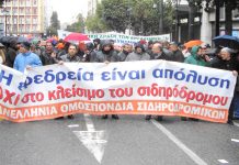 Rail workers marching during Tuesday’s general strike in Athens