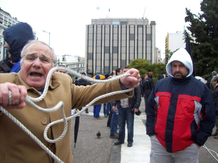 Worker showing the noose he wants to use on the bankers  during a demonstration last Thursday in Athens