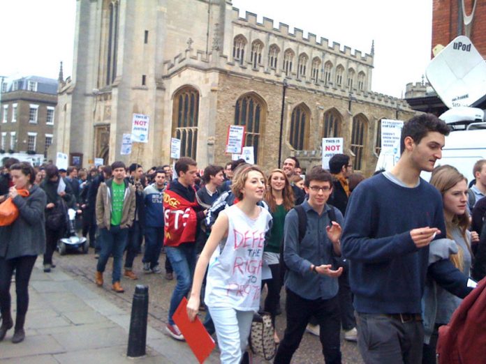 Students and dons marched in Cambridge yesterday afternoon demanding the reinstatement of Owen Holland
