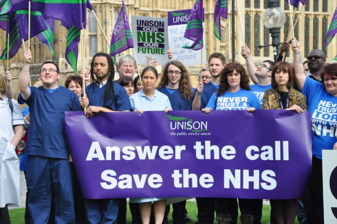 Unison members outside Parliament yesterday afternoon showing their determination to save the NHS