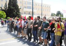 Athens university students marching past the Greek Parliament building on May Day – are calling for capitalism to be overthrown