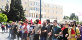 Athens university students marching past the Greek Parliament building on May Day – are calling for capitalism to be overthrown