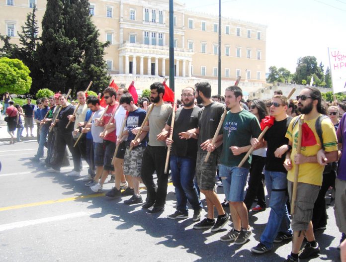 Athens university students marching past the Greek Parliament building on May Day – are calling for capitalism to be overthrown