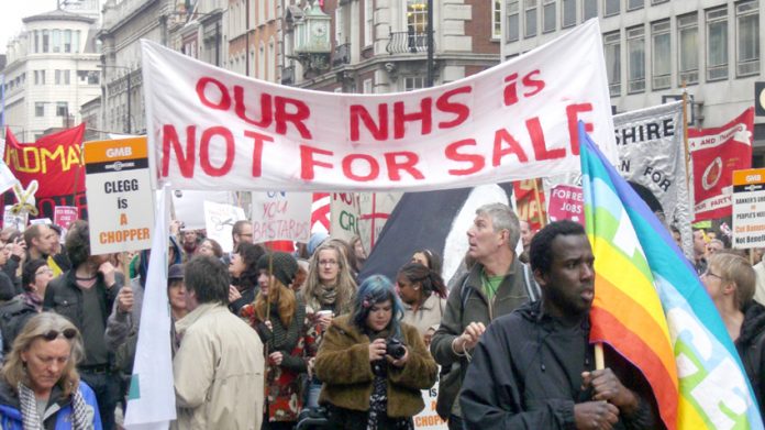 Hospital workers march against the coalition’s NHS cuts