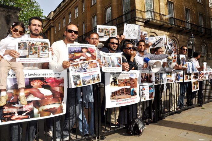 Libyans demonstrate outside Downing Street on Thursday against the NATO-imposed rebel regime in Libya