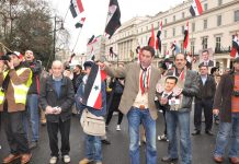 Syrians show their support for President Assad outside their embassy in London on March 17, the day after a terror bombing in Damascus killed 25