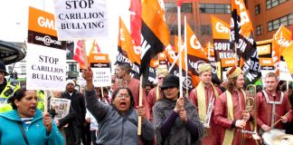 GMB hospital workers marching through Swindon against the bullying of privateer company Carillion