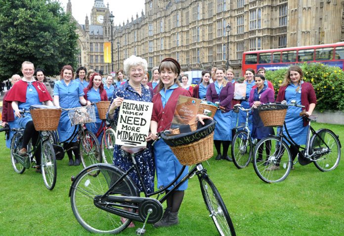 Royal College of Midwives president Lesley Page with midwifery students on vintage cycles yesterday demanding 5,000 more midwives