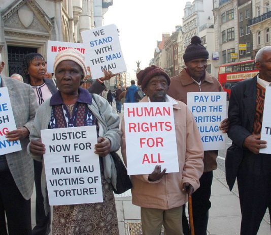 Mau Mau supporters outside the High Court demanding that the British government be held to account for mass murder in Kenya