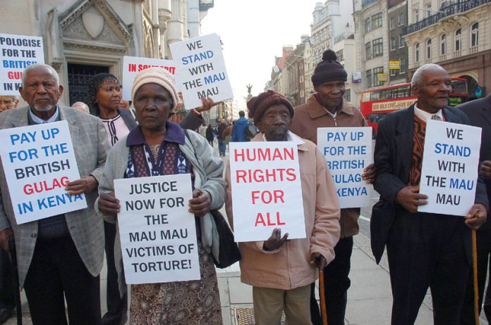 Mau Mau supporters outside the High Court demanding that the British government be held to account for mass murder in Kenya