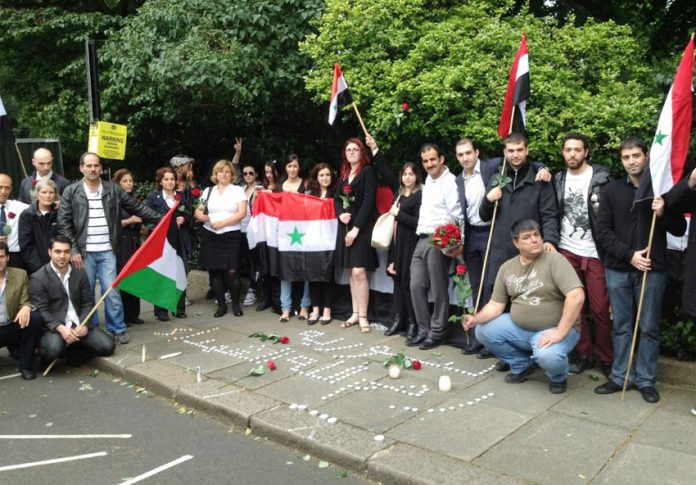 Syrians hold a vigil outside their embassy in London last Thursday to commemorate the Syrian government leaders who died in that day’s terrorist bombing in Damascus