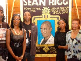 Marcia Rigg (2nd left) and Samantha Rigg-David (2nd right) with supporters and the Justice for Sean Rigg banner