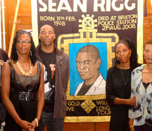 Marcia Rigg (2nd left) and Samantha Rigg-David (2nd right) with supporters and the Justice for Sean Rigg banner