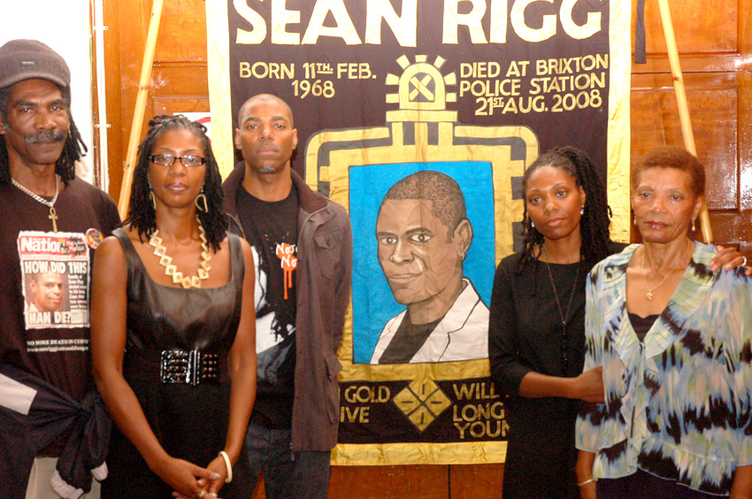 Marcia Rigg (2nd left) and Samantha Rigg-David (2nd right) with supporters and the Justice for Sean Rigg banner