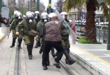 Greek worker stands his ground against an attack by riot police