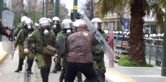 Greek worker stands his ground against an attack by riot police