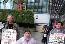 Protesters outside the ATOS headquarters in Euston point to the damage that ATOS, a sponsor of the Paralympics, has done to disabled people