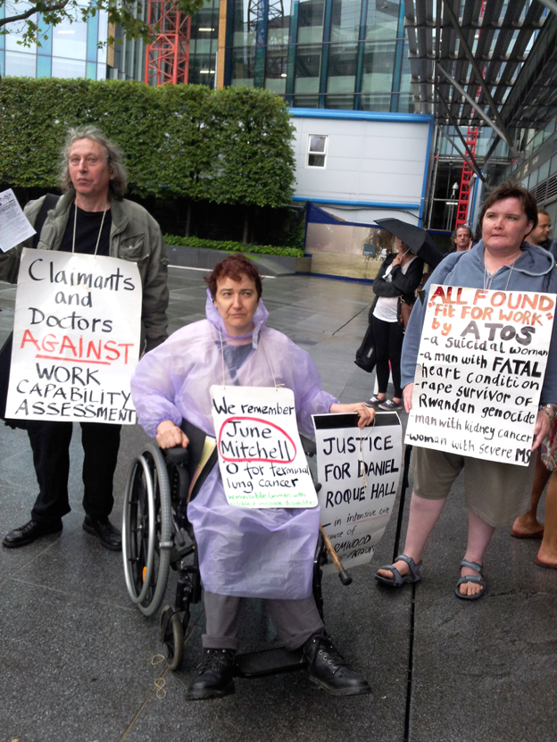 Protesters outside the ATOS headquarters in Euston point to the damage that ATOS, a sponsor of the Paralympics, has done to disabled people