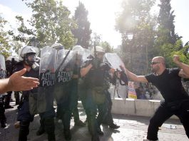 Greek worker takes on riot police during 120,000-strong march in Athens on Thursday’s general strike