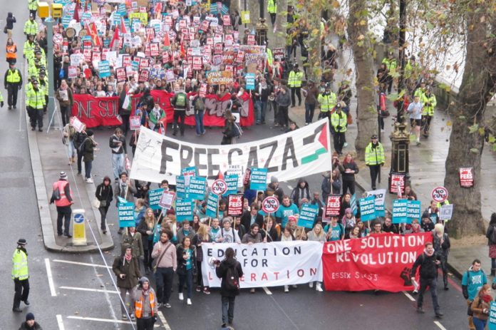 The front banners set the tone for the demonstration – solidarity with the Palestinians and Revolution is the Solution!