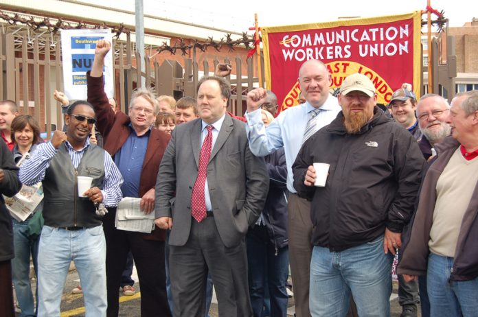 CWU leaders BILLY HAYES and DAVE WARD (centre figures) on the picket line at Mandela Way in south east London during the last national strike action in 2009