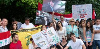 Syrian youth outside their embassy in London last August showing their support for president Assad