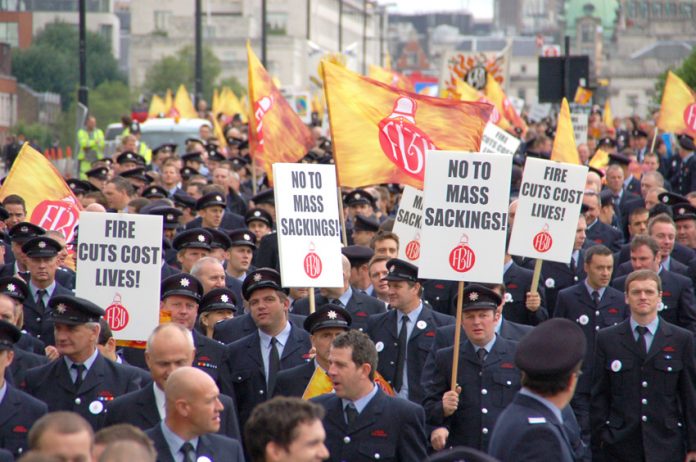 London firefighters demonstrating against mass sackings and emphasising that closing fire stations and cutting the service will cost lives