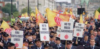 Firefighters marching in London with a current message that the fire service must be defended otherwise lives will be lost