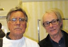 MIKE ABBOTT with KEN LOACH holding up a copy of ‘The Key to My Cell’ by Des Warren, the story of the building  workers’ strike and the way in which it was attacked by the  capitalist state