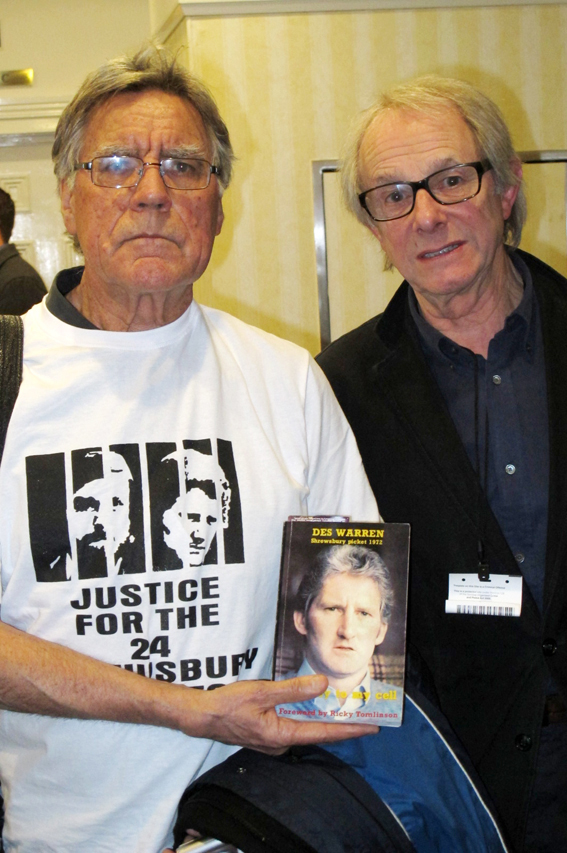 MIKE ABBOTT with KEN LOACH holding up a copy of ‘The Key to My Cell’ by Des Warren, the story of the building  workers’ strike and the way in which it was attacked by the  capitalist state