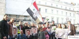 Syrians demonstrate outside the Syrian embassy in London in support of President Assad and against the armed gangs