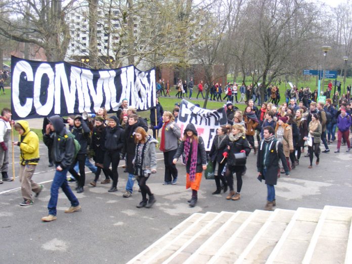 Students march through the campus their main banner displaying their hostility to capitalism and privatisation